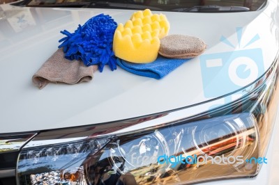 Yellow, Green Sponges And Blue Mitts For Washing And Microfiber Fabric With Cleaner Cloth On White Car Stock Photo