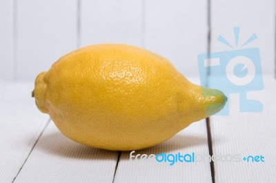 Yellow Lemon Over White Wood Background Stock Photo
