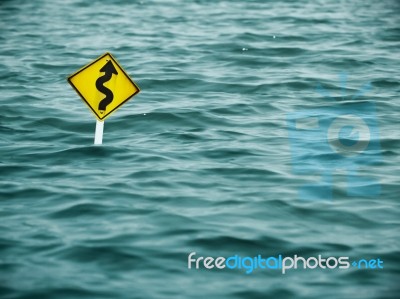 Yellow Sign Of Road In Water Stock Photo