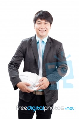Young Asian Engineering Man Standing And Holding Safety Helmet I… Stock Photo