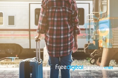 Young Asian Tourist With Luggage Waiting Train In Station Stock Photo