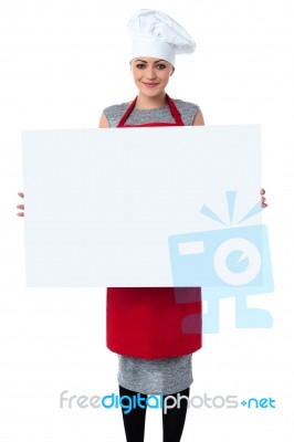 Young Baker Woman Holding A Blank Whiteboard Stock Photo