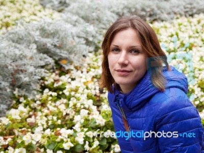 Young Beautiful Girl Near Flower Beds Stock Photo