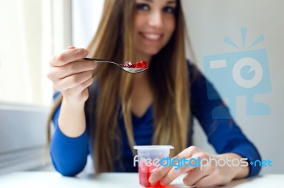 Young Beautiful Woman Eating Yogurt At Home Stock Photo