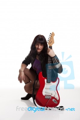 Young Beautiful Woman With Guitar In The Studio Stock Photo