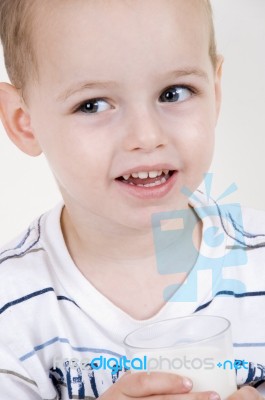 Young Boy Holding Milk Glass Stock Photo