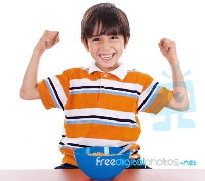 Young Boy Shows His Strength By Raising His Arms Stock Photo