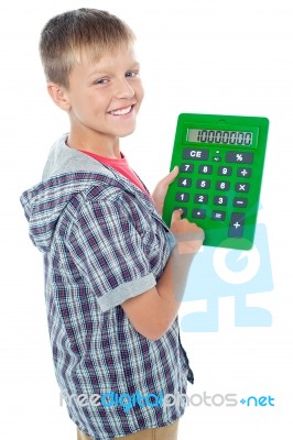 Young Boy Using Calculator Stock Photo