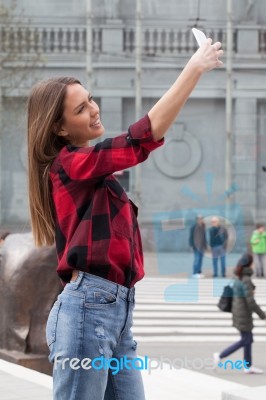 Young Brunette With A Smart Phone Stock Photo