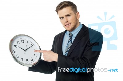 Young Business Man Holding Wall Clock Stock Photo