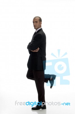 Young Businessman Standing On One Leg Stock Photo