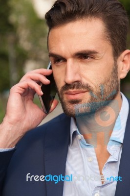 Young Businessman Using His Mobile Phone Stock Photo