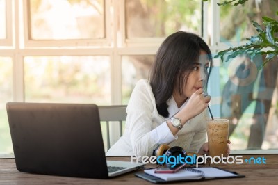 Young Businesswoman Working In Coffee Shop Stock Photo