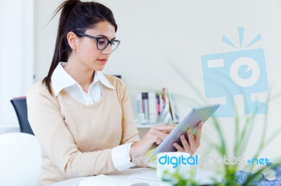 Young Businesswomen Working With Digital Tablet In Her Office Stock Photo