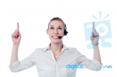 Young Call Center Woman Pointing Up Stock Photo