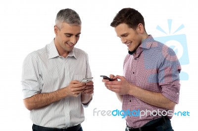 Young Casual Men Using Their Smart Phone Stock Photo