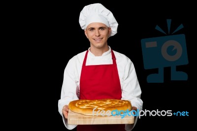 Young Chef Holding Big Bread Stock Photo