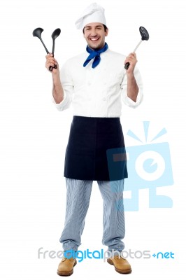 Young Chef Holding Kitchen Utensils Stock Photo