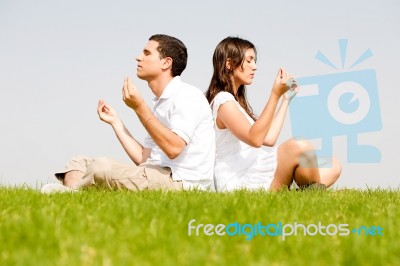 Young Couple Doing Meditation Stock Photo