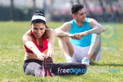 Young Couple Doing Stretching Stock Photo