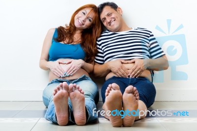 Young Couple Expecting Baby. Isolated On White Stock Photo