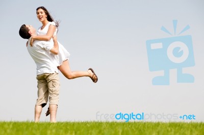 Young Couple Fooling Around On The Park Stock Photo
