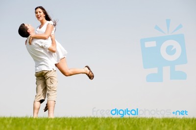 Young Couple Fooling Around On The Park Stock Photo