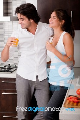 Young Couple In Kitchen Stock Photo