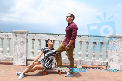 Young Couple In Love Outdoor With Skateboard Stock Photo