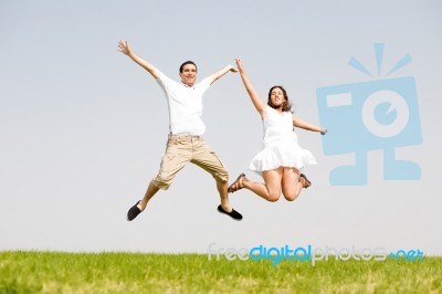 Young Couple Jumping Stock Photo