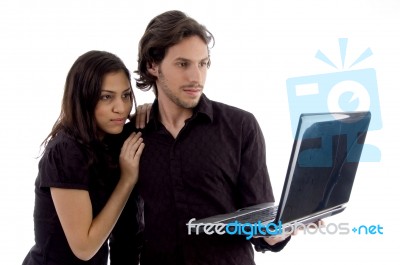 Young Couple Looking Into Laptop Stock Photo