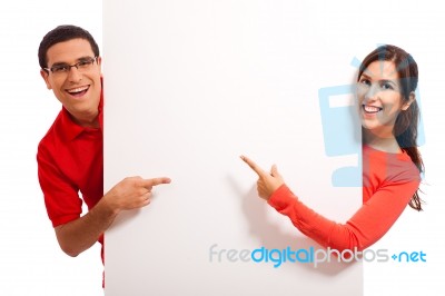 Young Couple Pointing Stock Photo