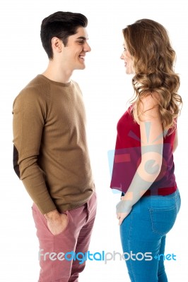 Young Couple Standing Face To Face Stock Photo