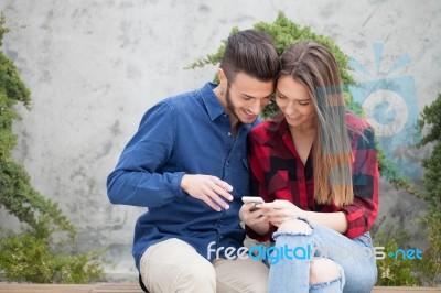 Young Couple Using Smart Phone Stock Photo