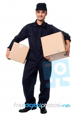 Young Courier Boy Holding Parcels Stock Photo