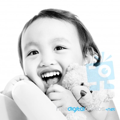 Young Cute Girl Hugging A Teddy Bear Stock Photo