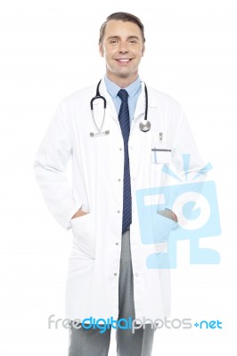 Young Doctor Posing With Hands In His Overcoat Stock Photo