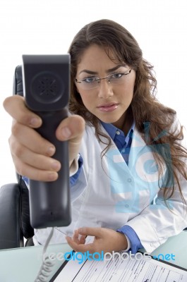 Young Doctor Showing Phone Receiver Stock Photo