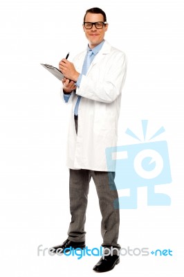 Young Doctor Writing Medical Report Stock Photo