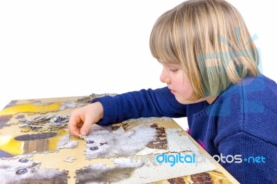 Young Dutch Girl Making Jigsaw Puzzle On Table Stock Photo Young Dutch Girl Making Jigsaw Puzzle On Table Stock Photo