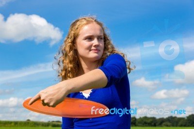 Young Dutch Woman Throwing Orange Frisbee Stock Photo