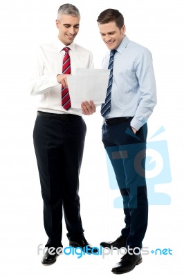 Young Executives Discussing Business Reports Stock Photo
