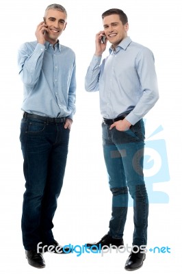 Young Executives Talking Through Mobile Phone Stock Photo
