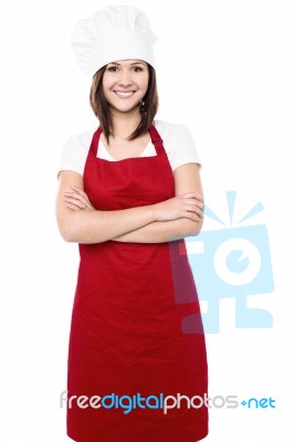 Young Female Chef With Folded Arms Stock Photo