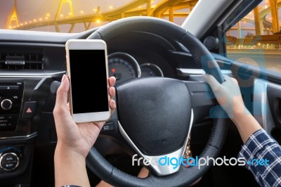 Young Female Driver Using Touch Screen Smartphone And Hand Holdi… Stock Photo