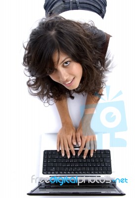 Young Female Lying On Floor Working On Laptop Stock Photo