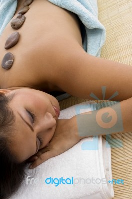 Young Female Taking Stone Therapy Stock Photo