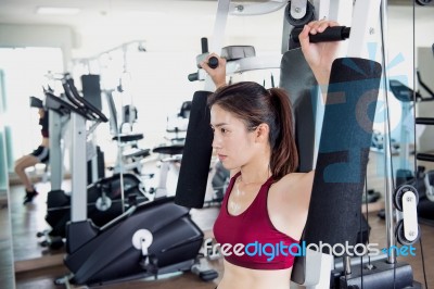 Young Fitness Woman Executed Exercise With Exercise-machine In Gym Stock Photo Young Fitness Woman Executed Exercise With Exercise-machine In Gym Stock Photo