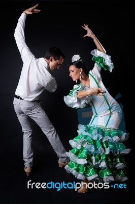 Young Flamenco Dancers In Beautiful Dress On Black Background Stock Photo