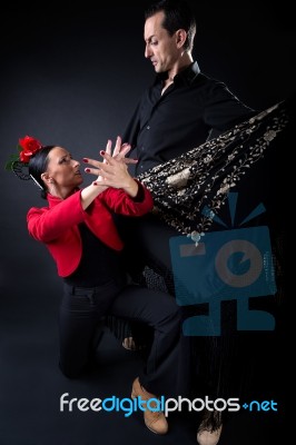 Young Flamenco Dancers In Beautiful Dress On Black Background Stock Photo